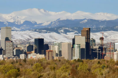 Denver city skyline with snowy mountains in the background.