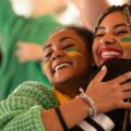 female die-hard football fans celebrating their team's victory