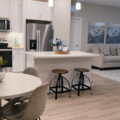 A stylish, open floor plan apartment kitchen and living room.