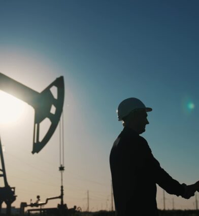 Handshake between worker and businessman in oil and gas industry