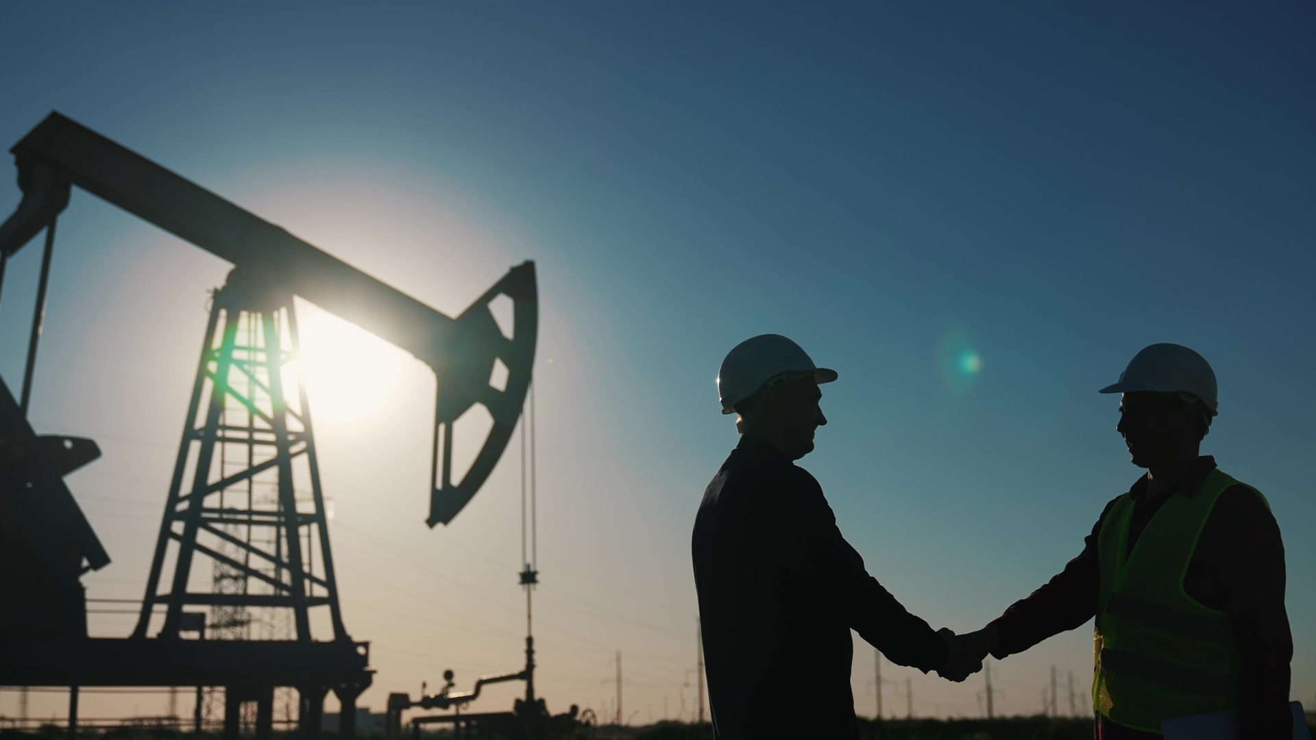 Handshake between worker and businessman in oil and gas industry