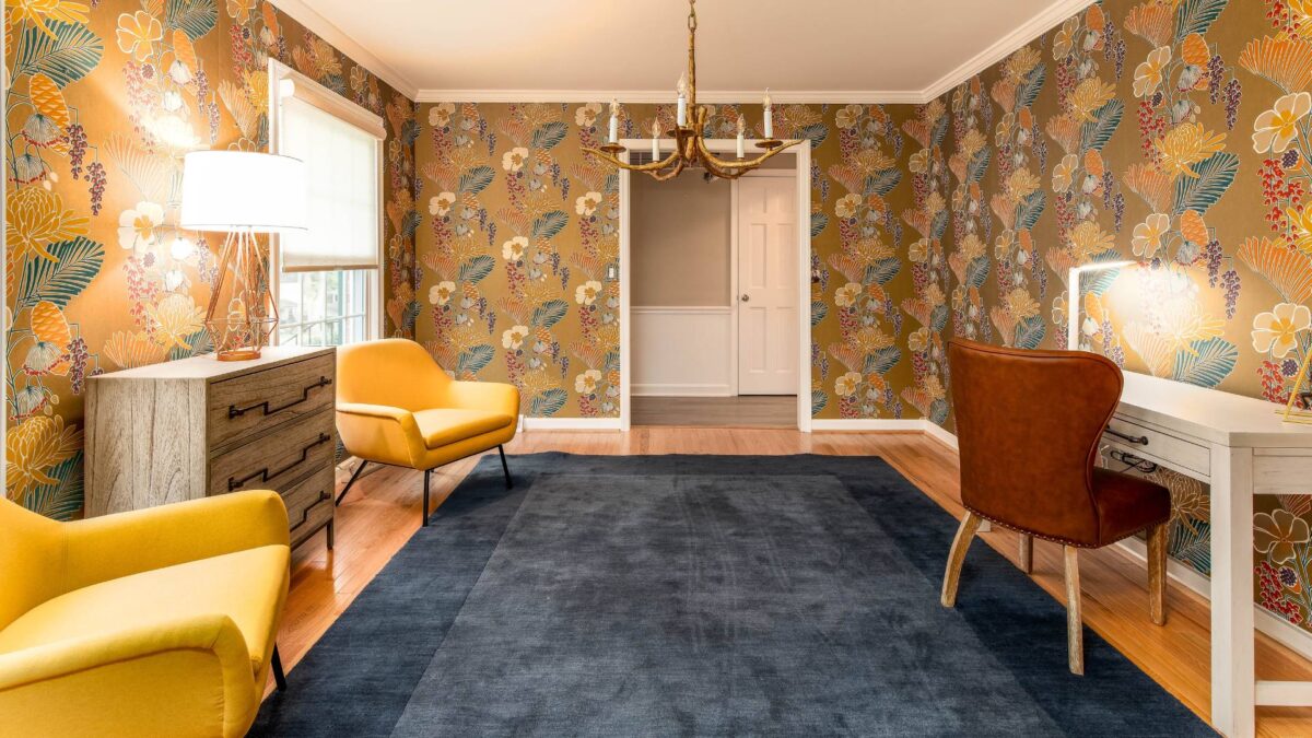 How to make a space truly yours without buying new furniture: vibrant room with yellow armchairs, floral wallpaper, and modern rental pieces from CORT.