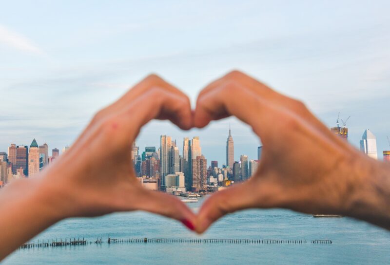 Hands making heart in front of NYC while preparing for an internship in NYC.