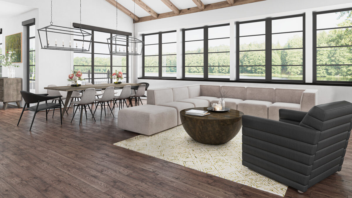 Stylish open-concept living and dining area with modern furniture rental from CORT, featuring the Marin sectional, black arm chair, lark cocktail table, and additional wooden accents